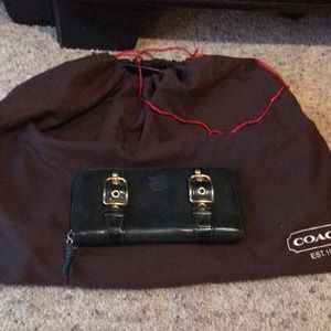 Black Coach lg zip around wallet w/ gold hardware.